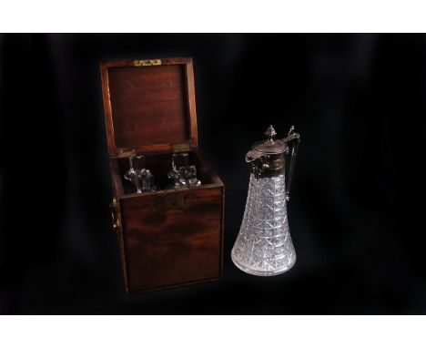 A mahogany cased George III four bottle decanter set, together with a silver plated and cut glass claret jug, plus an octagon