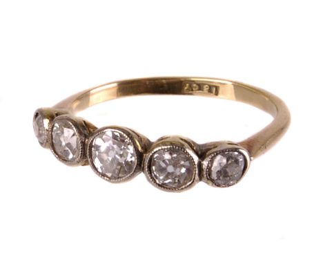 An early 20th century five stone diamond ring, the graduated spectacle set old stones totalling approx. 0.86cts, to a yellow 