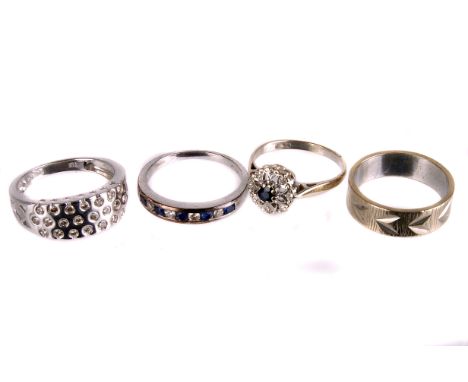 Three white gold gem set rings,  including a diamond and sapphire half hoop eternity ring in 9ct gold mount, a diamond and sa