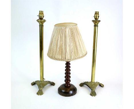 A pair of polished brass table lamps, with straight stems and fluted triangular bases raised on paw feet, 55 cm high, togethe