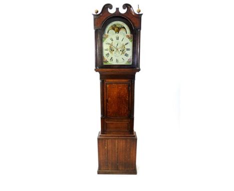 A George IV oak cross banded longcase clock, the broken scroll pediment above an arched glazed door flanked by fluted pilaste