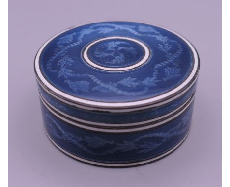 A Continental blue enamel decorated silver box. 4.5 cm diameter. 