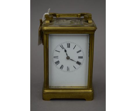 A brass cased carriage clock, with key. 17 cm high.