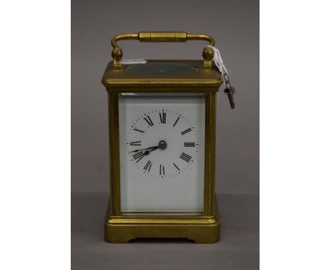 A French brass cased carriage clock. 15 cm high.