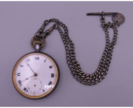 A Victorian pocket watch with a silver chain. 4.75 cm diameter.