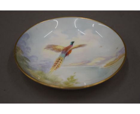A Minton hand painted pheasant dish, signed K Scott.