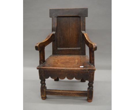 An 18th century and later oak converted child's commode chair. 45 cm wide.