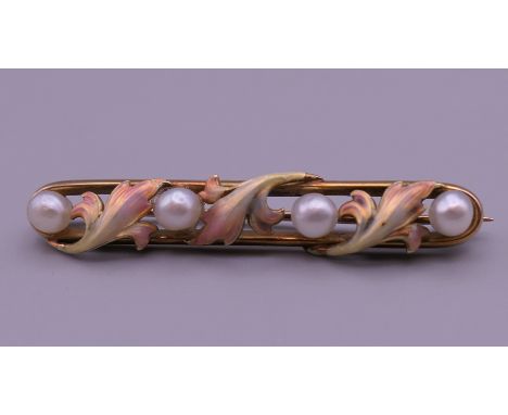 A Belle Epoque period 14 K gold pearl and three coloured enamel brooch. 4.5 cm long. 5 grammes total weight.
