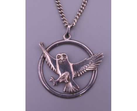 A silver pendant on chain formed as an owl. The pendant 4 cm wide. 30.9 grammes.