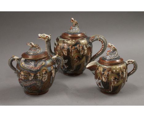 A Satsuma three-piece tea set. The teapot 17 cm high.