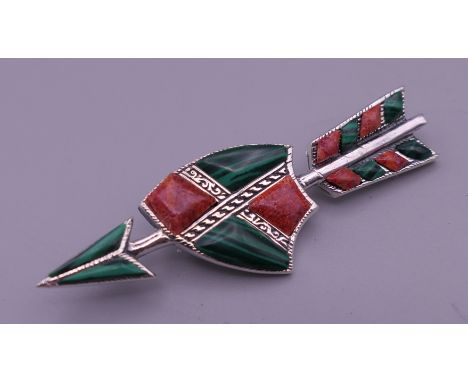 A silver malachite and coral arrow brooch. 5.5 cm long.