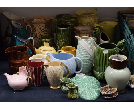 A large quantity of ceramic jugs, vases, etc., including Wade, Sylvac, Wedgwood, etc.