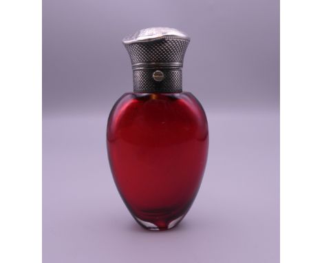 A Victorian silver topped cranberry glass scent flask. 9 cm high.