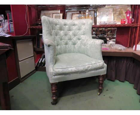 A 19th Century barrel-back armchair in green floral upholstery with deep button detail