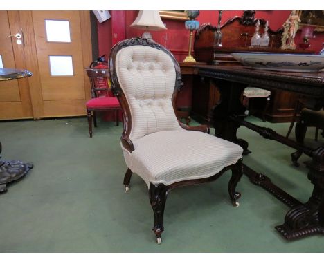 A circa 1860 lady's mahogany open armchair, carved spoon back over a serpentine front seat on scroll carved cabriole legs and