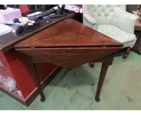 A George III oak tri-angular top lamp table, the rising leaves opening into a hexagonal top over pad foot straight cabriole l