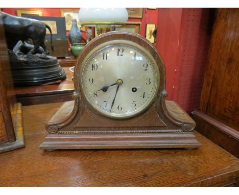 A 20th Century oak mantel clock with silvered dial 