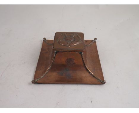 A Circa 1900 Art Nouveau copper inkwell with floral embossed lid, ceramic liner