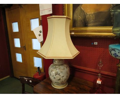 A ceramic table lamp in the form of a ginger jar, cream ground with pink, green and gilt flower and blossom design, cream sha