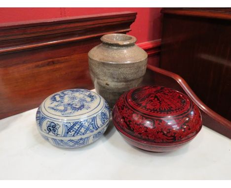 An Oriental black and terracotta lacquered pot, a blue and grey ceramic pot and a stoneware crackled vase 