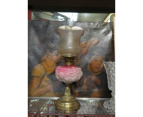 A Victorian etched glass oil lamp with pink moulded reservoir over brass base 