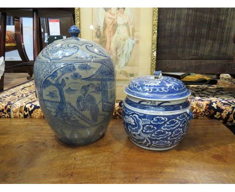 A large Oriental lidded jar and a blue and white pot with dragon design, dog of fo finial knop (2)