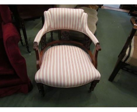 A circa 1900 walnut open armchair, scroll back rest over carved supports and bow front seat on ring turned legs and ceramic c