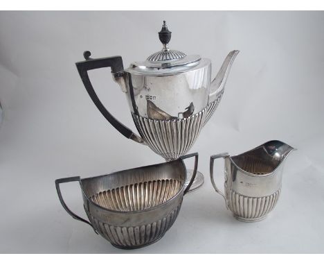 A silver three piece coffee set comprising, coffee pot, cream jug and twin handled sucrier, melon fluted half body, (coffee p