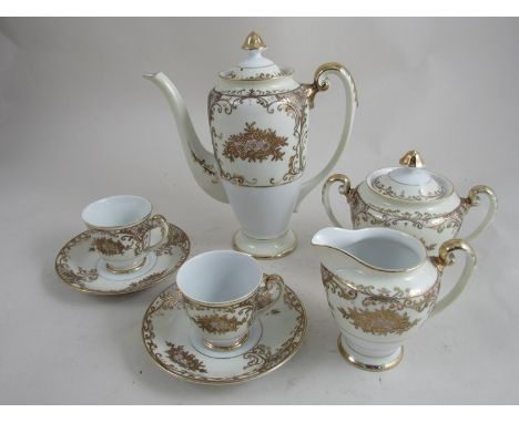 A Meito china hand painted coffee set, comprising coffee pot, lidded server, cream jug and six coffee cans and saucers, white