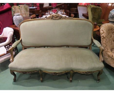 A French 19th Century gilt wood three seater sofa, with carved decoration, serpentine front seat over cabriole legs on castor