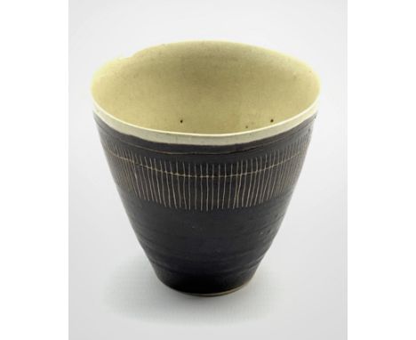 Dame Lucie Rie D.B.E (1902-1995) a stoneware beaker decorated to the exterior with sgraffito lines in a manganese glaze over 