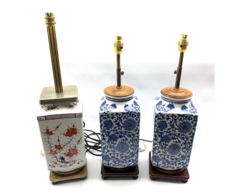 Pair of Oriental blue and white square section lamps on hardwood stands, H57cm and another similar lamp decorated in the Imar