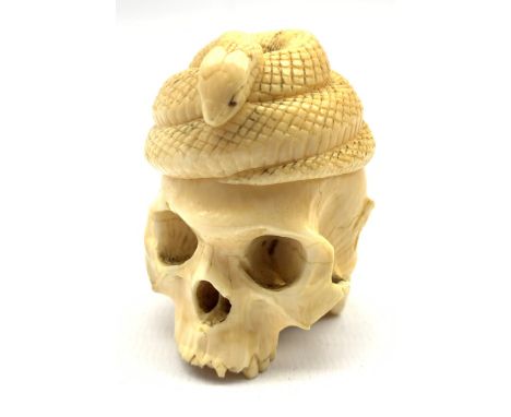 Late 19th century Japanese carved ivory okimono in the form of a skull beneath a coiled snake with a toad at the rear H5cm  -