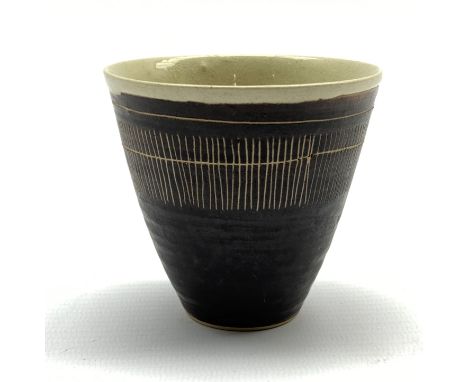Dame Lucie Rie D.B.E (1902-1995) a stoneware beaker decorated to the exterior with sgraffito lines in a manganese glaze over 