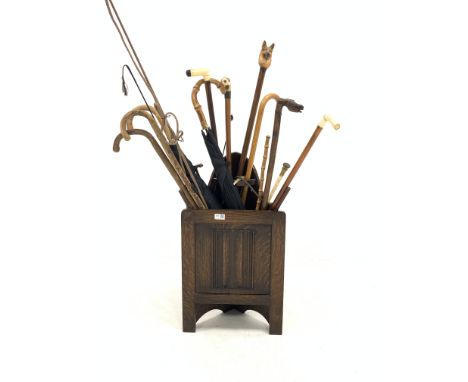 Oak corner stick stand containing various sticks, riding crop and whip, Greek stick with horses head etc - Condition Report 