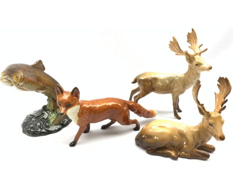 Beswick model of a Standing Stag No. 981, another of a Lying Stag No. 954, another of a Fox No. 1016A and another of a Trout 