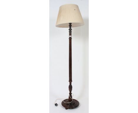 A 1950's mahogany standard lamp with reeded column and terraced base complete with the shade. H184 x W35cm 