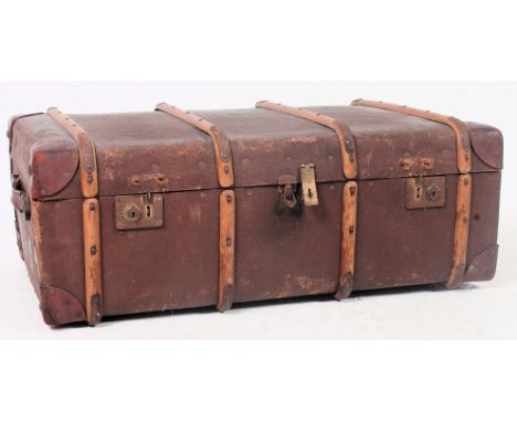 A vintage 20th century canvas and wooden bound steamer trunk with hinged centre and lined interior. H35 x W90 x D53cm 