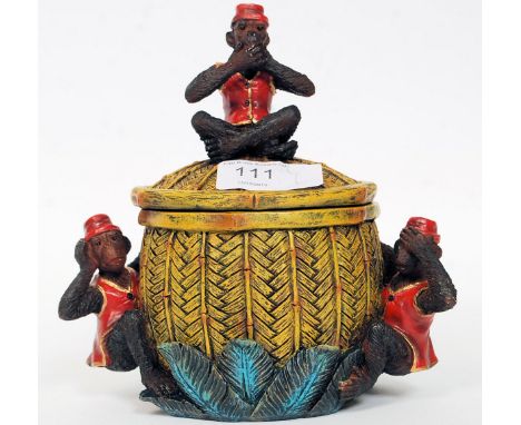 An unusual 20th century resin case painted tobacco jar adorned with monkeys surrounding bamboo effect pot. H17 cm 
