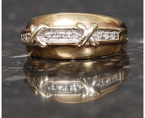 A 9ct gold hallmarked ring set with 10 x 1pt diamonds with a twin cross motif. Size L. 3.2g
