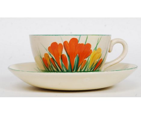 A Clarice Cliff globe shape teacup and saucer circa 1930's being hand painted with banded borders believed to be the Crocus P