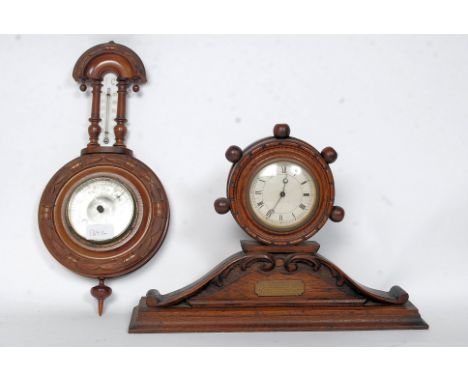 A 1920's Oak mantel barrel - wheel clock having inset swill movement. The clock with ball finials to the barrel case set on s