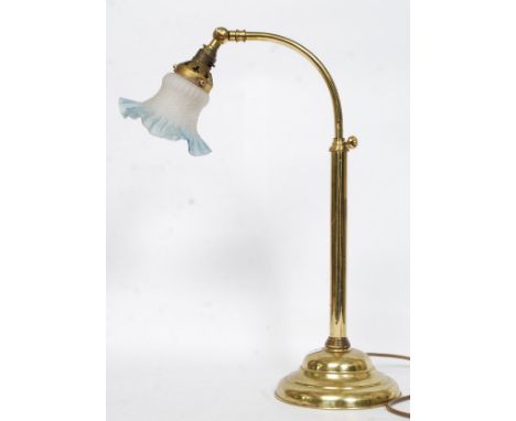 A good brass bankers lamp raised on angular stem with terraced base having frosted blue glass shade