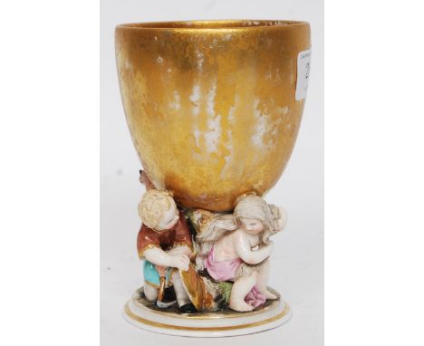 A late 19th century / early 20th century Meissen style ceramic cherub cup. Marks to base. H13 cm 