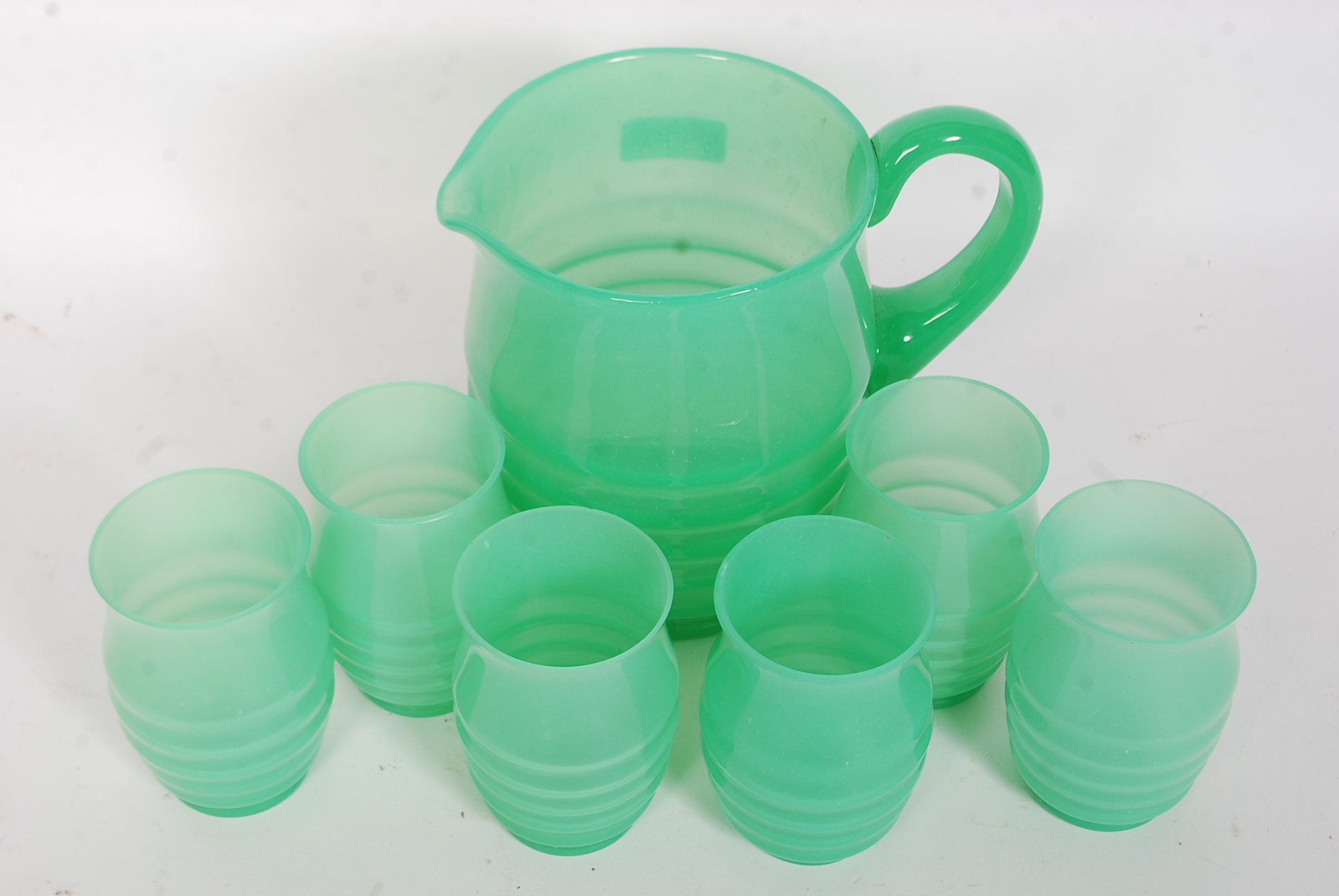 A stunning 1930's Art Deco green ribbed glass lemonade set. Comprising