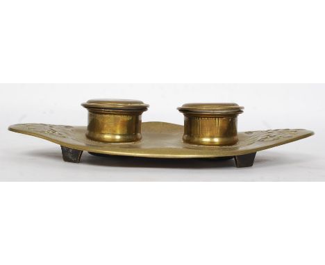 A 19th century Geschutzt brass inkwell in the high Art Nouveau form having twin wells with ceramic liners. Stamped to the bas
