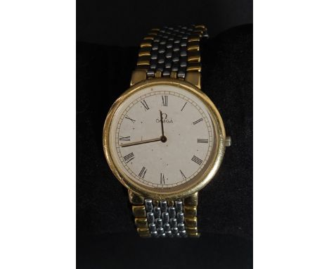An Omega De Ville quartz wristwatch having round face with cream textured dial and gilt hands. Roman numeral chapter ring. Se