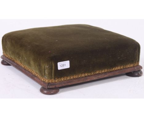 A 19th century large Victorian mahogany and green velour upholstered footstool, The padded feet with wooden plinth surround. 