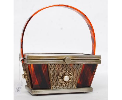 A 1950's vintage original Tyrolean tiger stripe lucite handbag.  The large hoop handle with rectangular sarcophagus form body
