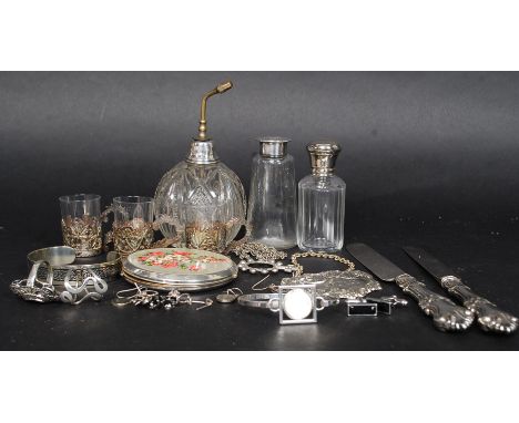 A collection of silver items and white metal items. To include silver marked rings along with white metal flatware, decanter 